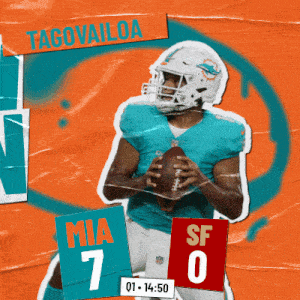a miami dolphins football player is holding a ball