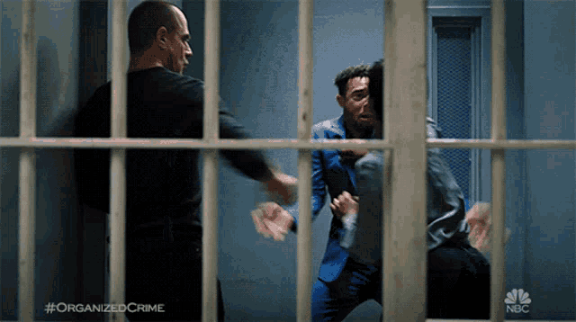 a man in a jail cell with #organizedcrime on the bottom