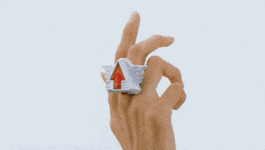 a person in a blue jacket is holding a piece of crumpled paper in their hand