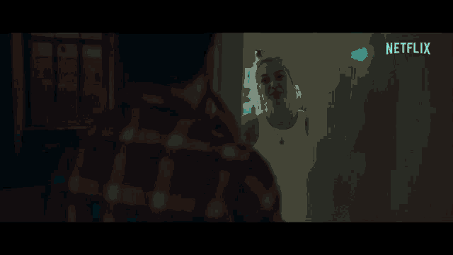 a blurry picture of a man in a dark room with a netflix logo on the bottom