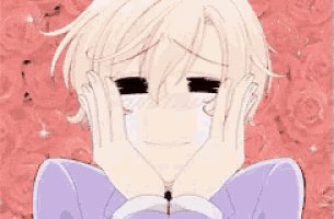 a boy is crying with his hands on his face .
