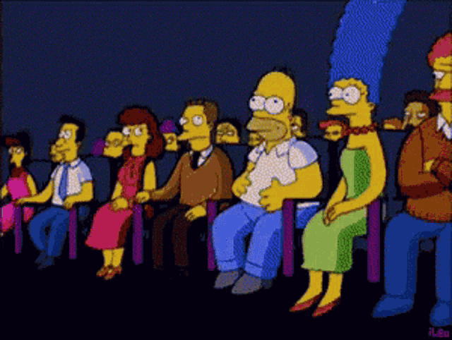 a group of simpsons characters sitting in a theater