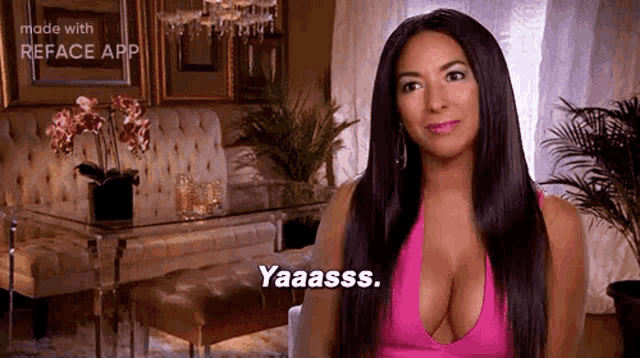 a woman with a very large breast is sitting in a living room .