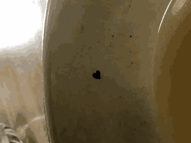 a close up of a white plate with a heart shaped hole