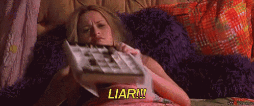 a woman is sitting on a bed holding a box of chocolates and says liar .