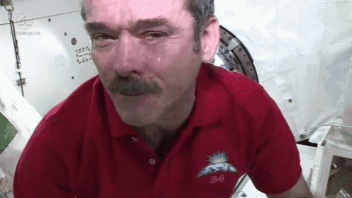 a man with a mustache is wearing a red shirt that says s44 on it