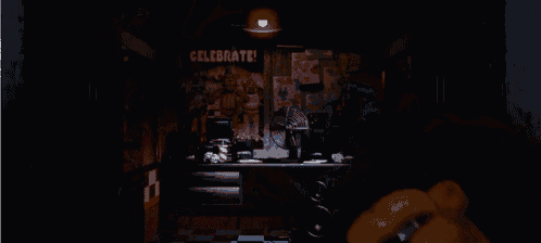 a dark room with a celebrate sign on the wall