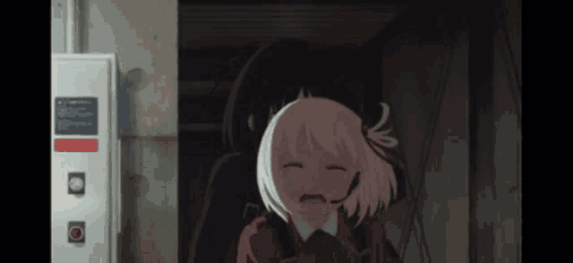a girl with a microphone on her head is crying in front of a wall