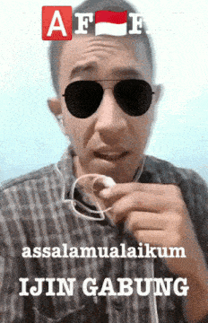 a man wearing sunglasses and ear buds is holding a piece of paper that says " ijin gabung "