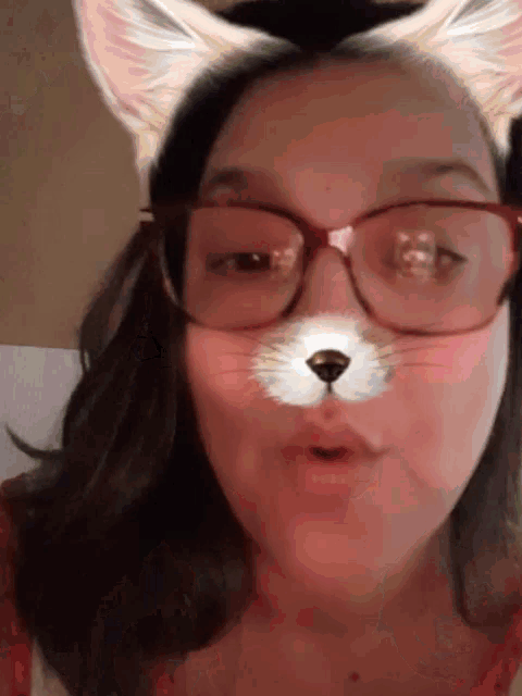 a woman wearing glasses and a cat face filter