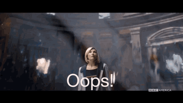a woman is standing in front of a building with the word oops written on the screen