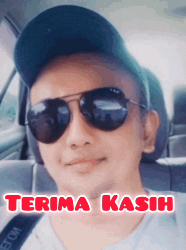 a man wearing sunglasses and a hat is sitting in a car with the words terima kasih above him