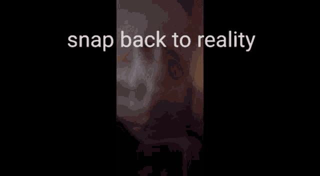 a blurred image of a person 's face with the words snap back to reality .