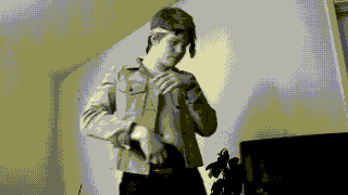 a pixelated image of a man standing in front of a tv