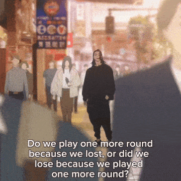 a man walking down a street with the words " do we play one more round because we lost "
