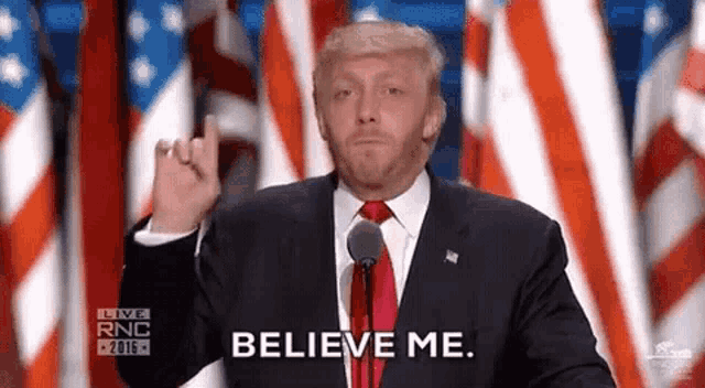 donald trump is giving a middle finger while giving a speech at a convention .