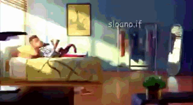 a man is laying on a bed in a room with the words sloano.if written on the wall