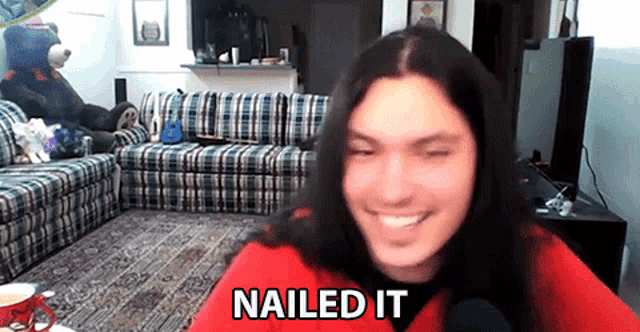 a woman with long hair is smiling in a living room with the words nailed it below her