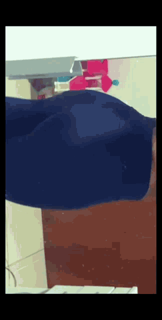 a person 's butt is reflected in a mirror