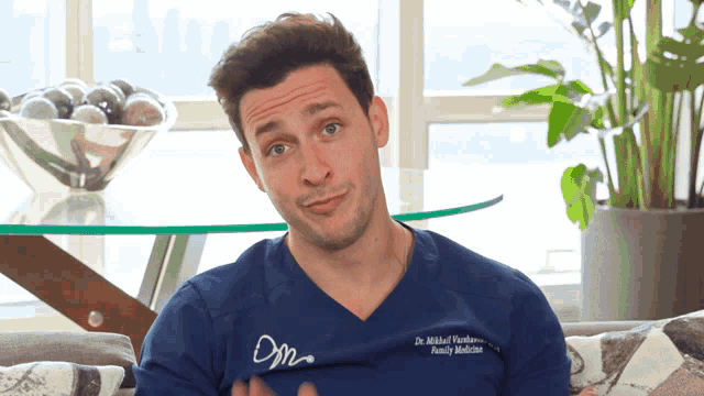 a man wearing a blue shirt that says family medicine on it
