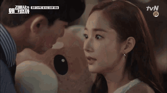 a man in a suit kisses a woman on the cheek in a tvn show