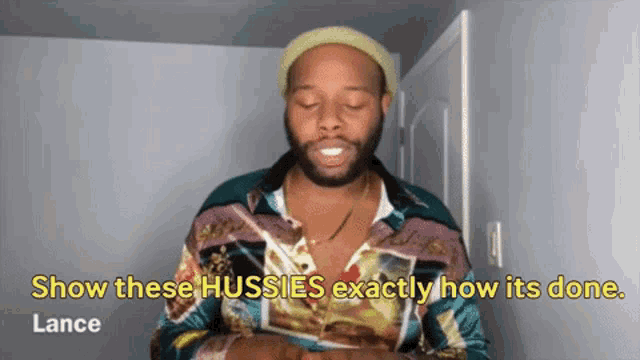 a man in a colorful shirt says show these hussies exactly how it 's done .