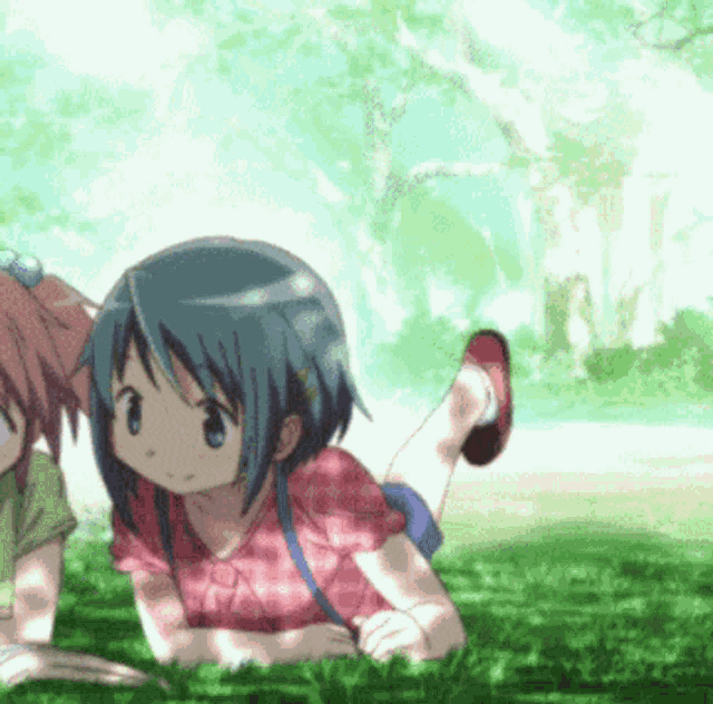 two anime girls are laying in the grass looking at something
