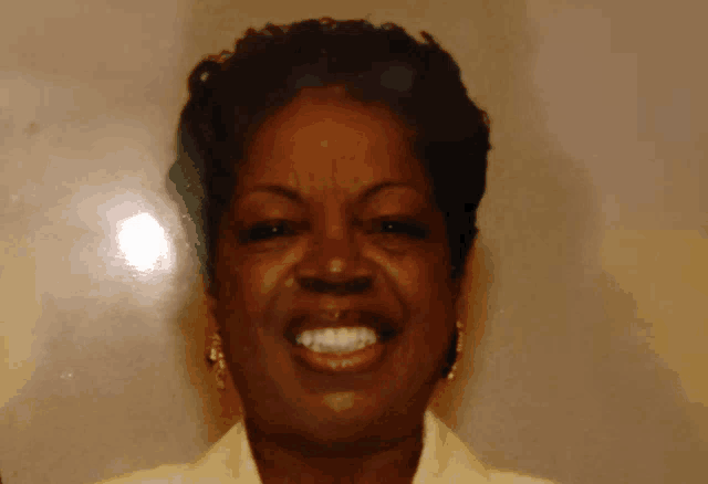 a close up of a woman 's face with her mouth open