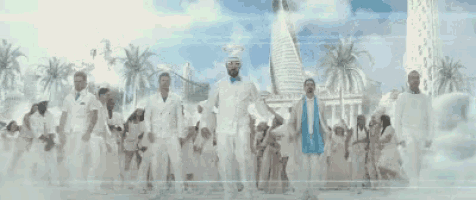 a group of people in white clothes are standing in front of a building .