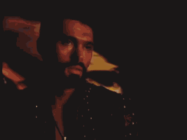 a man with a beard says " i love you xena " in a dark room