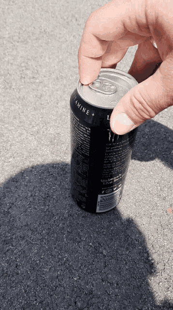a can of monster energy drink is being opened