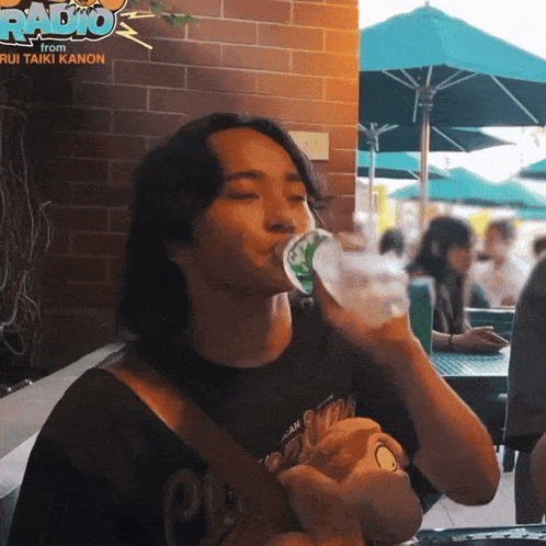 a man drinking water from a bottle with the words radio from rui taiki kanon on the bottom