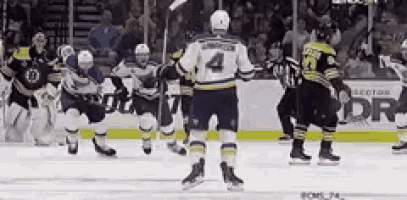 a hockey player with the number 4 on his jersey stands on the ice