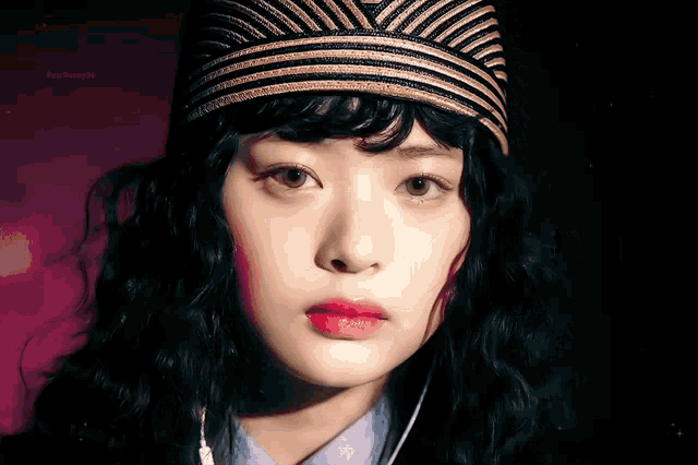 a close up of a woman 's face with a hat on