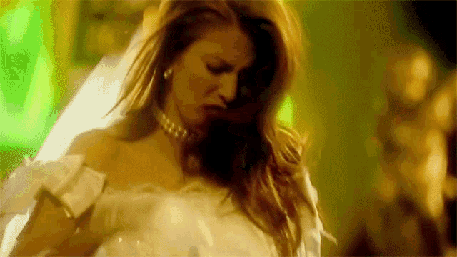 a woman in a white dress and pearls is dancing