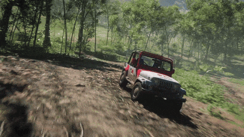 a red and white jeep is driving through a forest
