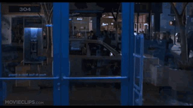 a movie clip from movieclips.com shows a t-rex attacking a building
