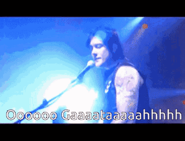 a pixelated image of a man singing into a microphone with the words " oooo gaaataaaahhhh " written below him