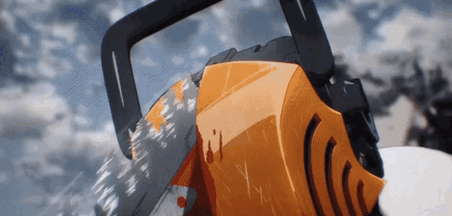 a close up of a chainsaw cutting through a snowy surface