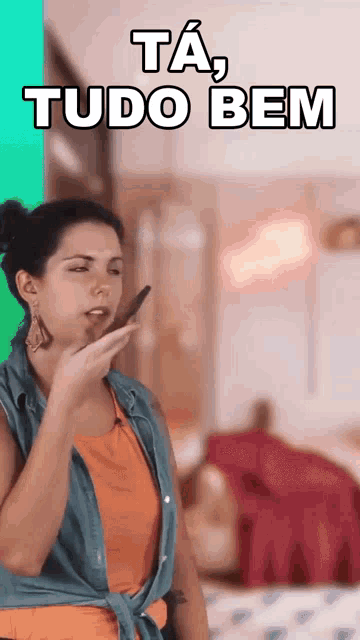 a woman is talking on a cell phone with the words ta tudo bem written above her