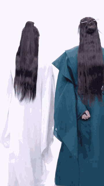 two people with long hair are holding hands and one has a ponytail