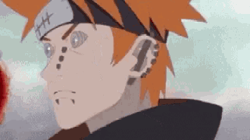 a close up of a cartoon character with red hair and a headband .