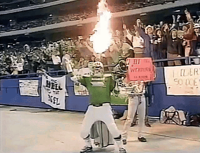 a person holding a sign that says " i elderly so doe " in front of a crowd