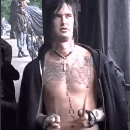 a shirtless man with a tattoo on his chest that says " lucky "