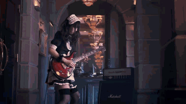a close up of a person playing a guitar with the letters prs on it