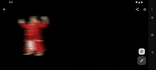 a phone screen shows a blurry picture of a person in a red coat
