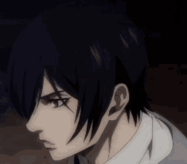 a close up of a man with black hair and a white shirt