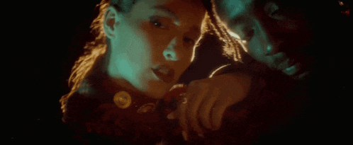 a man and a woman are hugging in the dark