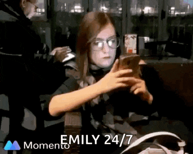 a girl wearing glasses is taking a picture of herself with a cell phone ..