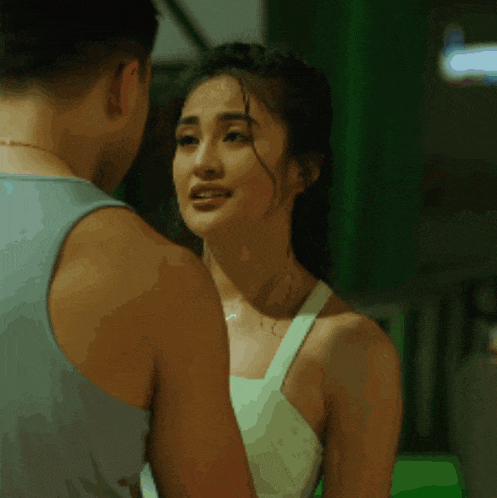 a man and woman are looking at each other